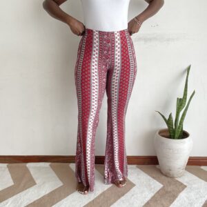 Red and white border-stripe ditsy print flare pants, front view