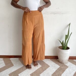 Solid rust orange tiered wide-leg pants, front view